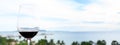 A glass of red wine on black table against the backdrop of the summer beach. Glasses of red wine on vacation. Wine tasting and