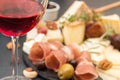 Glass of red wine and blur cheese plate with pieces moldy cheese Royalty Free Stock Photo