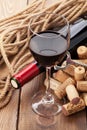 Glass of red wine, bottle and corks Royalty Free Stock Photo