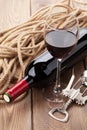 Glass of red wine, bottle and corkscrew Royalty Free Stock Photo
