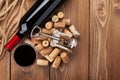 Glass of red wine, bottle and corkscrew on rustic wooden table Royalty Free Stock Photo