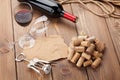 Glass of red wine, bottle and corkscrew on rustic wooden table Royalty Free Stock Photo