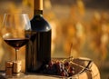 Red wine, bottle and grapes with blur country landscape. Alcohol drinks with bokeh effect of rustic fall background. Generative AI