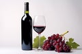 Glass of red wine, bottle and grapes on white background Royalty Free Stock Photo
