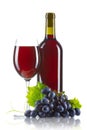 Glass of red wine with bottle and ripe grapes isolated Royalty Free Stock Photo