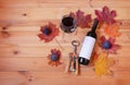 Glass of red wine, bottle of wine, autumn leaves, figs and corkscrew. Top view, copy space Royalty Free Stock Photo