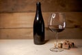 A glass of red wine with bottle and wine corks Royalty Free Stock Photo