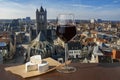 Glass of red wine with brie cheese against view of big cathedral in Ghent, Belgium Royalty Free Stock Photo