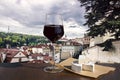 Glass of red wine and brie cheese in cafe with view of street in Prague, Czech Republic. Street with beautiful view on historic Royalty Free Stock Photo