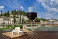 Glass of red wine and brie cheese with view of the Roman ruins and river in Verona, Italy. View of Roman Theater Royalty Free Stock Photo