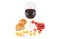 A glass of red wine , bunch of grapes , baguette and cheese isolated on a white