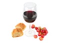 A glass of red wine , bunch of grapes and baguette isolated on a whit