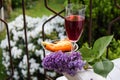 A glass of red wine with cheese on the balcony of the house in f