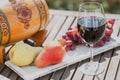 Glass of red wine with cheese and grapes on wooden table Royalty Free Stock Photo