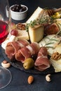Glass of red wine and cheese plate with pieces moldy cheese, pro Royalty Free Stock Photo