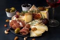 Glass of red wine and cheese plate with pieces moldy cheese, pro Royalty Free Stock Photo