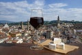 Glass of red wine with cheese with view from above of Florence historic city center in Italy
