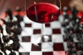 A glass of red wine on a chessboard. Royalty Free Stock Photo