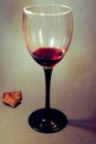 A glass of red wine with chocolate slices