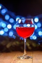 A glass of red wine. Concept of Happy Christmas, New Year, Winter, Greeting, Holiday, Alcohol. Royalty Free Stock Photo