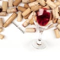 Glass of red wine with corks and corkscrew on a white background with copy space, top shot Royalty Free Stock Photo