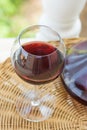 Glass with Red Wine and Crystal Decanter on Wicker Table in Garden Terrace of Luxurious Villa or Mansion. Authentic Lifestyle Royalty Free Stock Photo