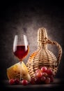 Glass of red wine with decanter and grapes Royalty Free Stock Photo