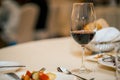 Glass of red wine and dinner on a set table. a restaurant. waiting for the meeting Royalty Free Stock Photo