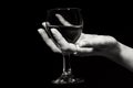 Glass with a red wine in a female hand Royalty Free Stock Photo