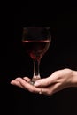 Glass with a red wine in a female hand Royalty Free Stock Photo