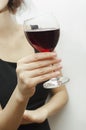 A glass of red wine in a female hand, close-up Royalty Free Stock Photo