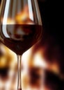 Glass of red wine and fire place Royalty Free Stock Photo
