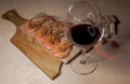 A glass of red wine with fried shrimps