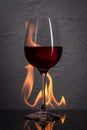 Glass. Red wine glass with fire splash in front of stone granit Royalty Free Stock Photo