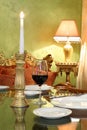 Glass with red wine and gold candlestick Royalty Free Stock Photo