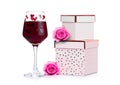 Glass of red wine with heart and pink gift box Royalty Free Stock Photo