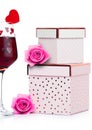 Glass of red wine with heart and pink gift box Royalty Free Stock Photo