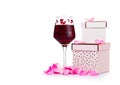 Glass of red wine with heart and pink gift box Royalty Free Stock Photo