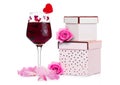 Glass of red wine with heart and pink gift box Royalty Free Stock Photo