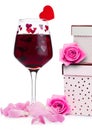 Glass of red wine with heart and pink gift box Royalty Free Stock Photo