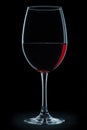 Glass with red wine isolated on black background