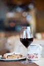 Glass of red wine and Linzer cake in cafe. Hiking in Dolomites, Italy