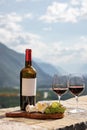 Glass of red wine and mountains on background. Swiss cheese and wine Royalty Free Stock Photo