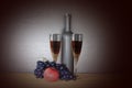 Glass of red wine near wine bottle next to apple and bunch of grapes Royalty Free Stock Photo