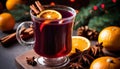 A glass of red wine with an orange slice and cinnamon sticks