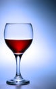 Glass of red wine over blue Royalty Free Stock Photo