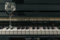 Glass of red wine on piano keyboard. Music and wine concept Royalty Free Stock Photo