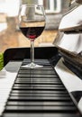 Glass of red wine on piano keyboard. Music and wine concept Royalty Free Stock Photo