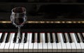 Glass of red wine on piano keyboard. Music and wine concept Royalty Free Stock Photo