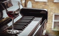 Glass of red wine on piano keyboard. Music and wine concept Royalty Free Stock Photo